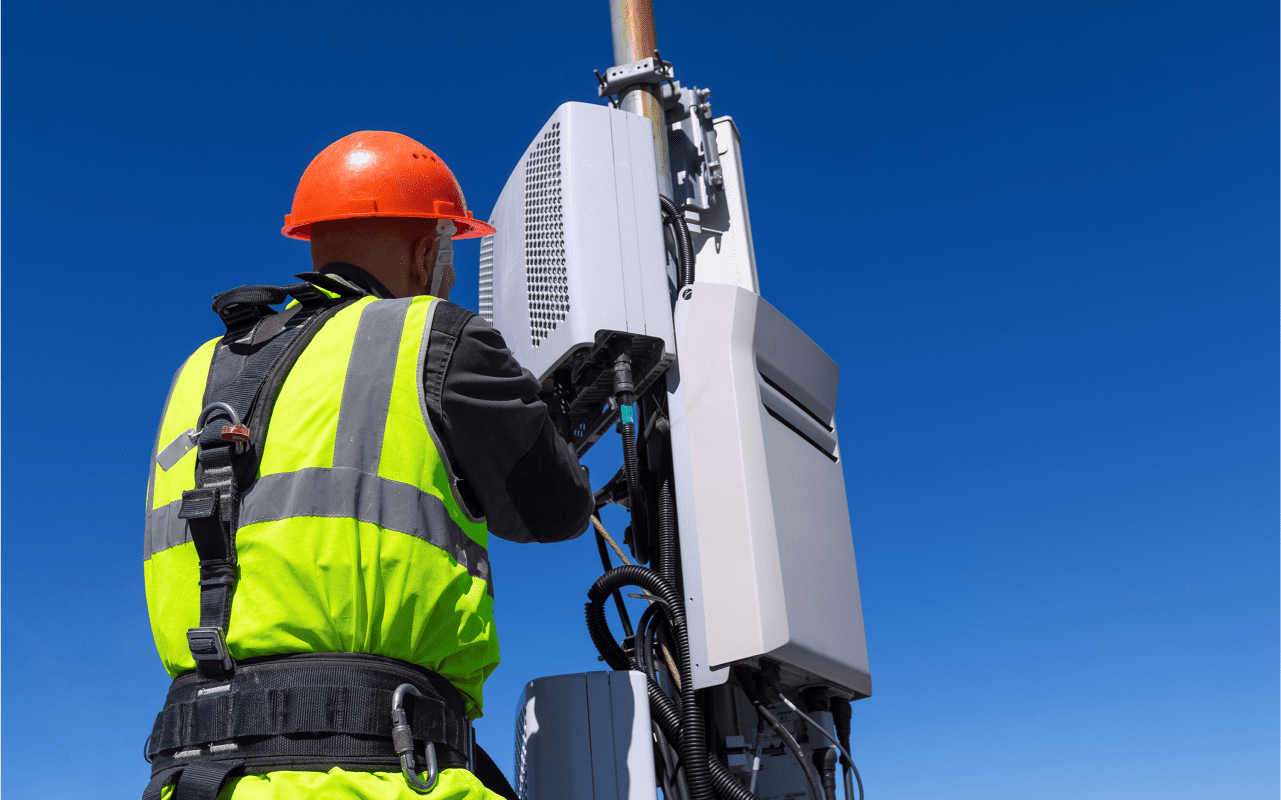 Technician working on cellular tower equipment.