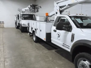 Utility trucks parked in a garage.