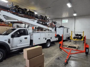 Utility truck and equipment inside a warehouse.