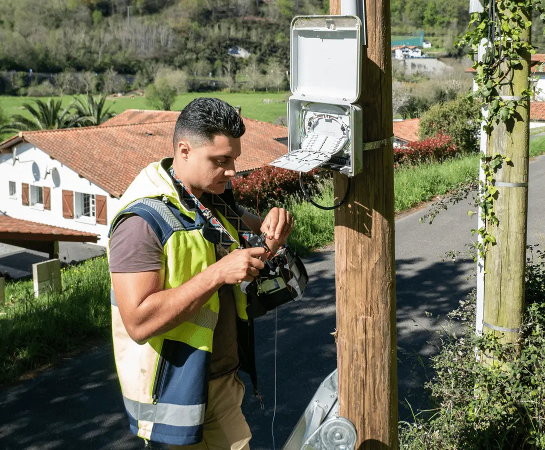 Technician working on outdoor electrical box.