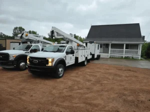Utility trucks parked near residential house.